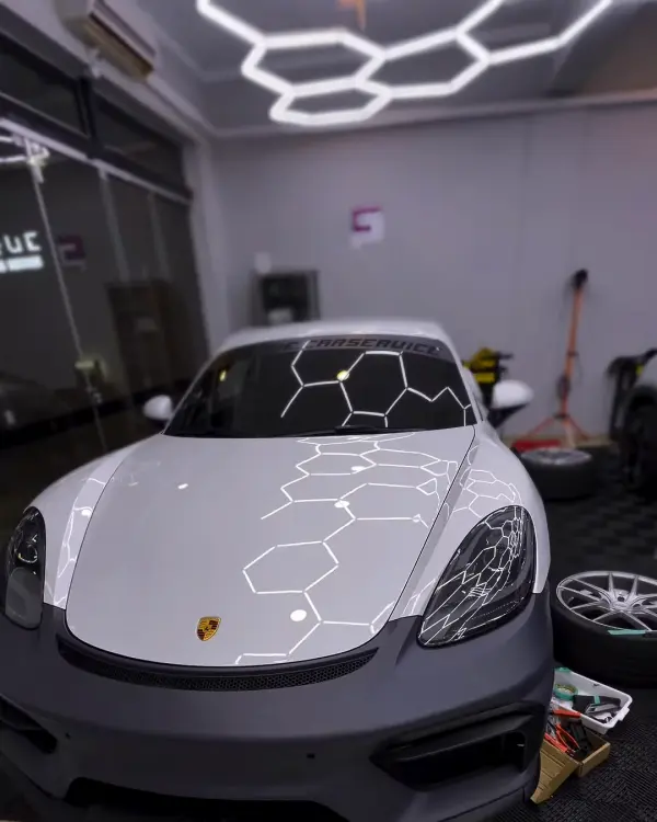 Porsche Cayman sob o teto de LED hexagonal do estúdio da Unique